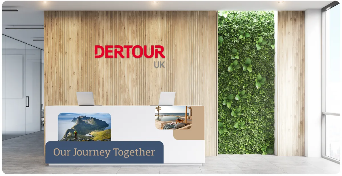 DERTOUR UK brand experience in a reception environment, the red wordmark on a timber wall beside a living-plant feature.